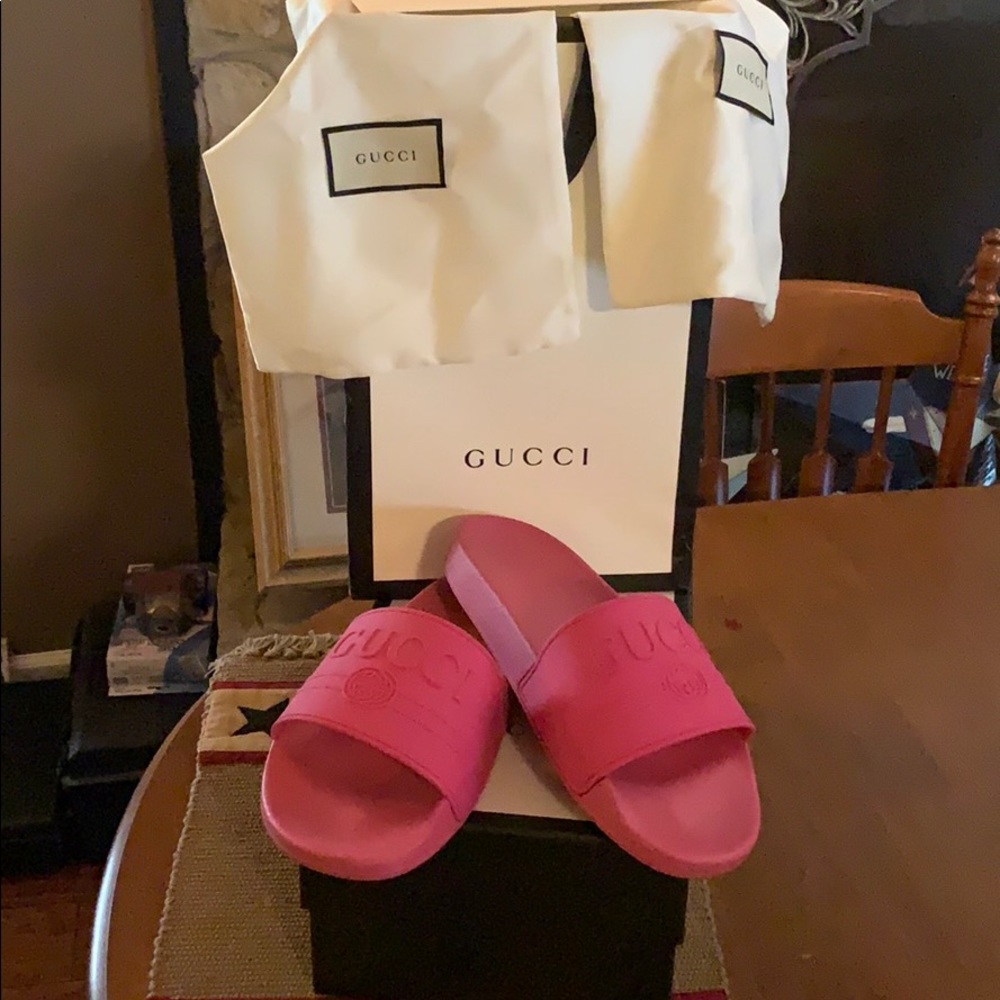 One pair of Gucci slides. Comes with box and bag.